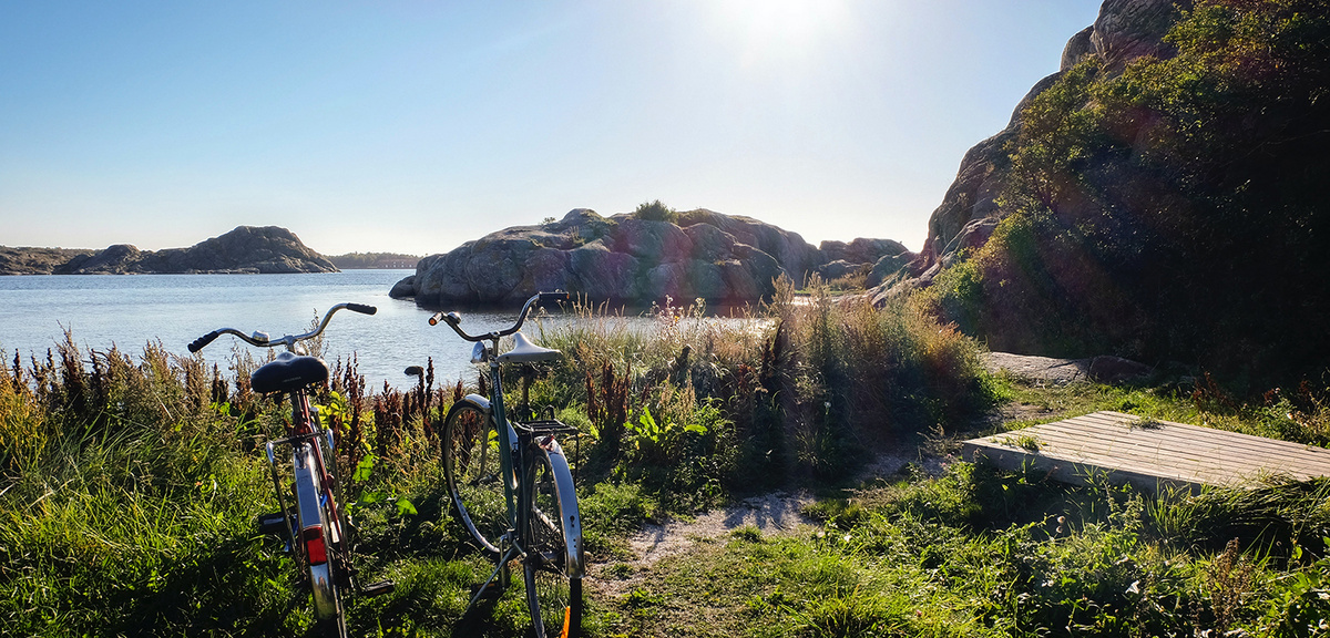 Two bicyles parked on the beach