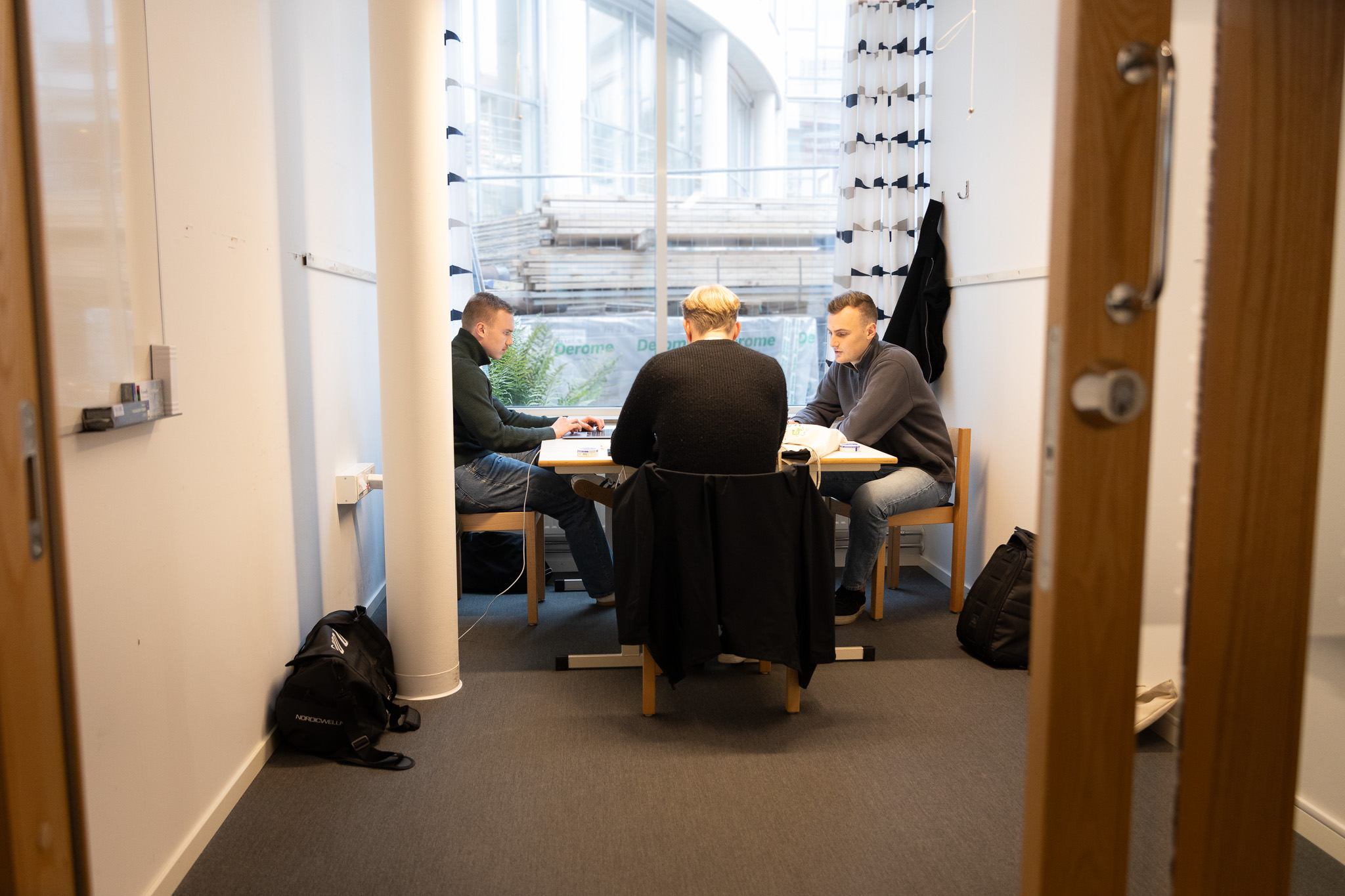 Three students working in a group room