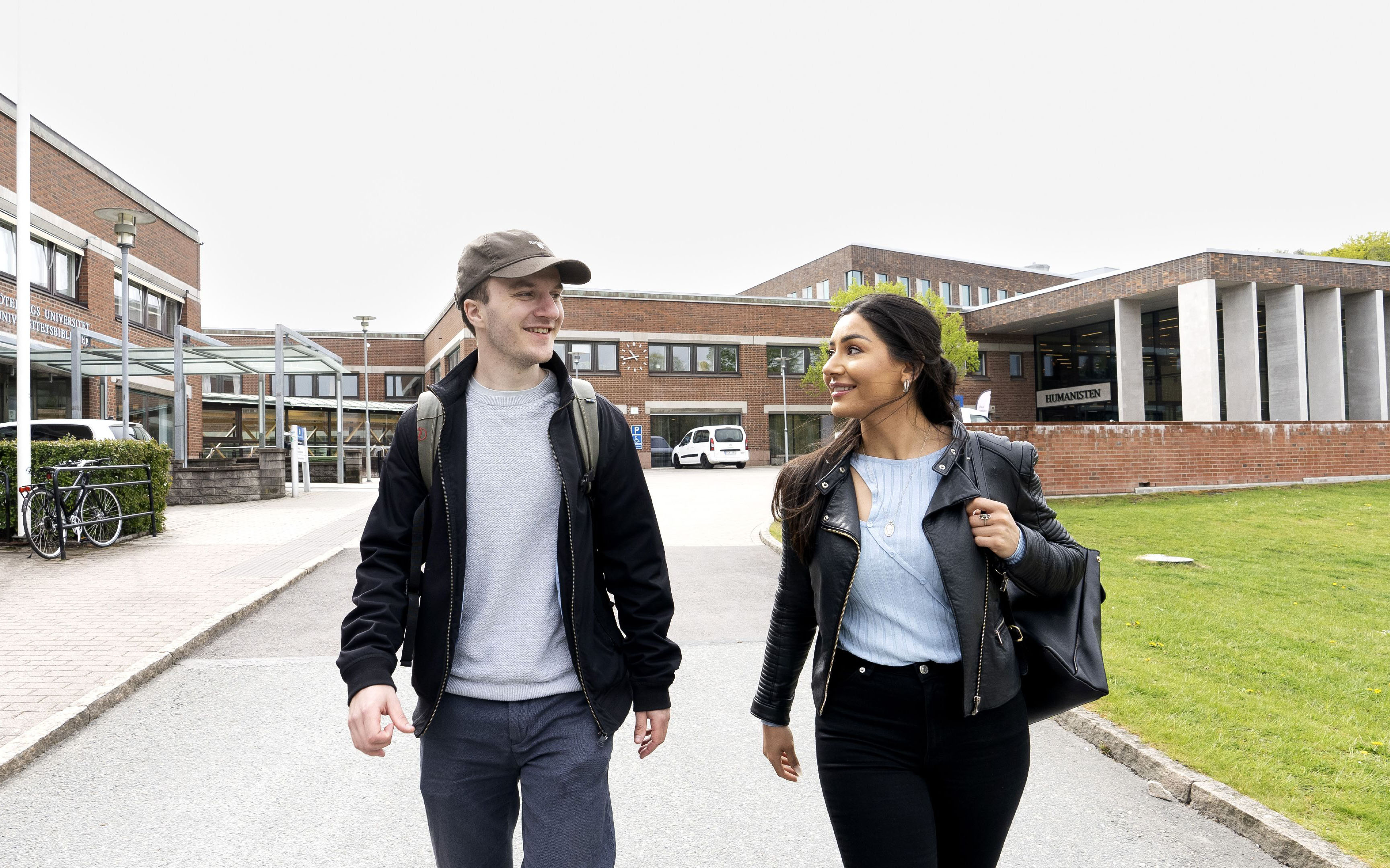 Two persons in front of the humanities library