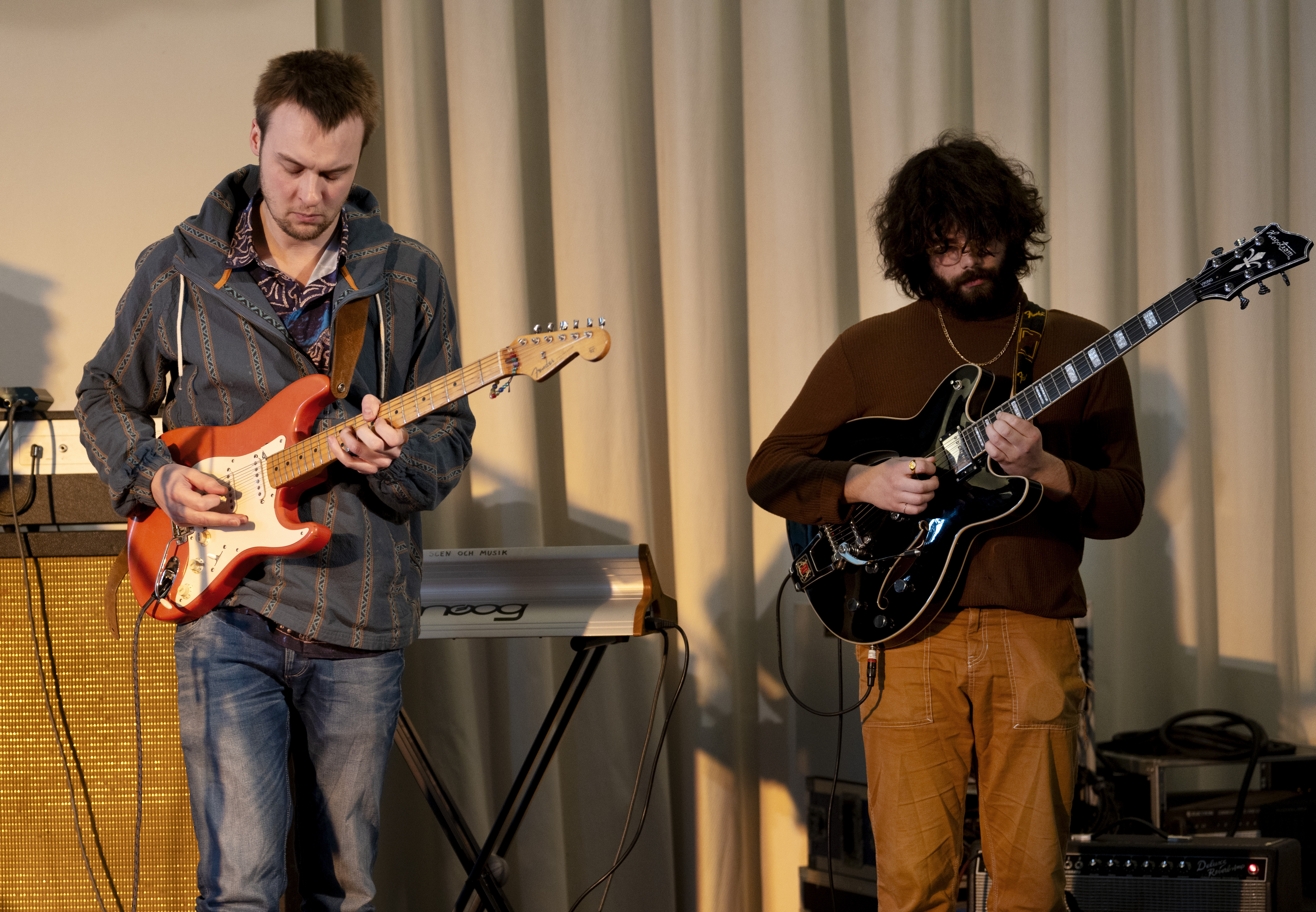 Two persons with electric guitars