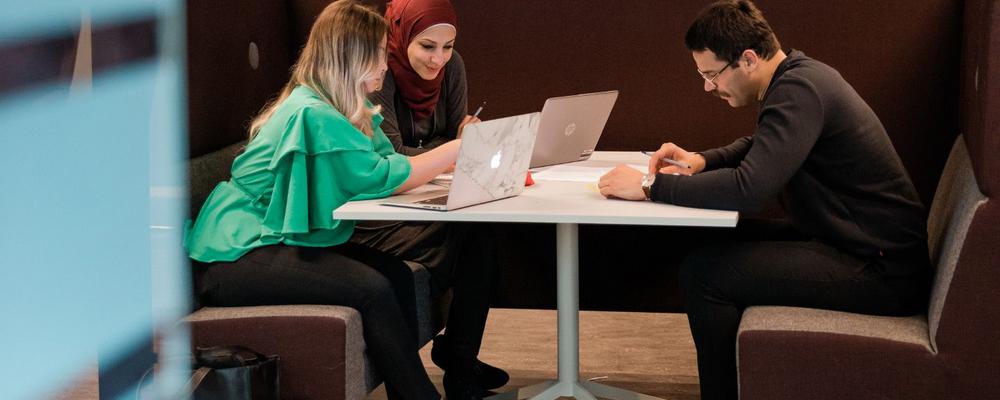 Studenter med datorer i b-huset på Pedagogen