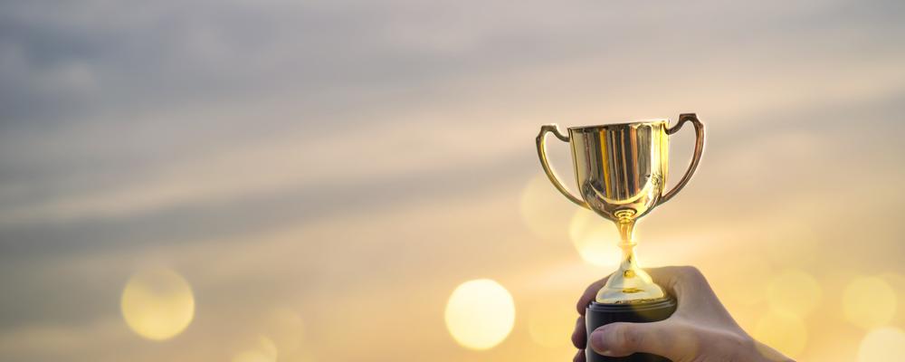 Hand holding a prize cup