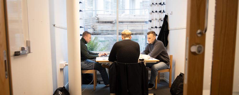 Three students working in a group room