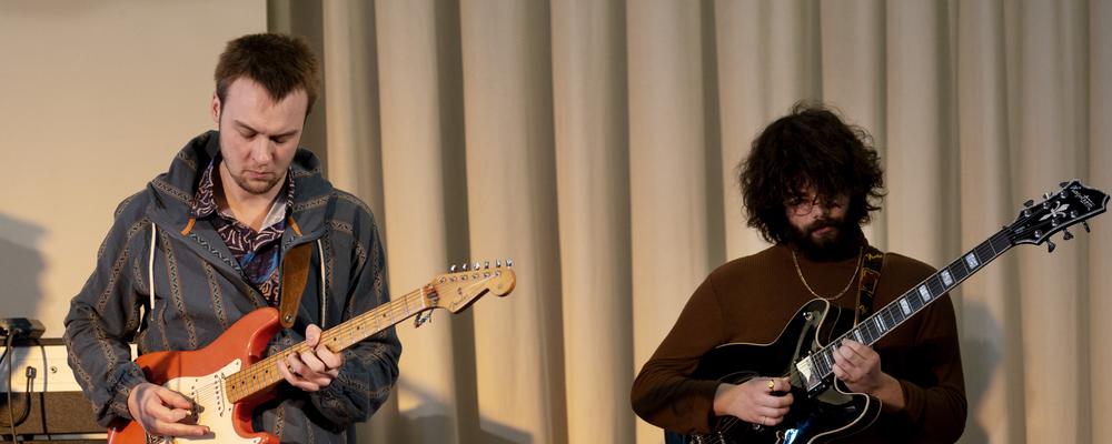 Two persons with electric guitars